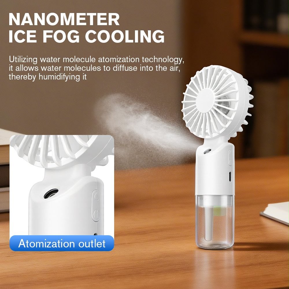 A small white handheld fan cooler with a clear water reservoir, shown on a wooden table with mist coming from the fan. The image includes marketing text about nanometer ice fog cooling and a close-up inset labeled atomization outlet.