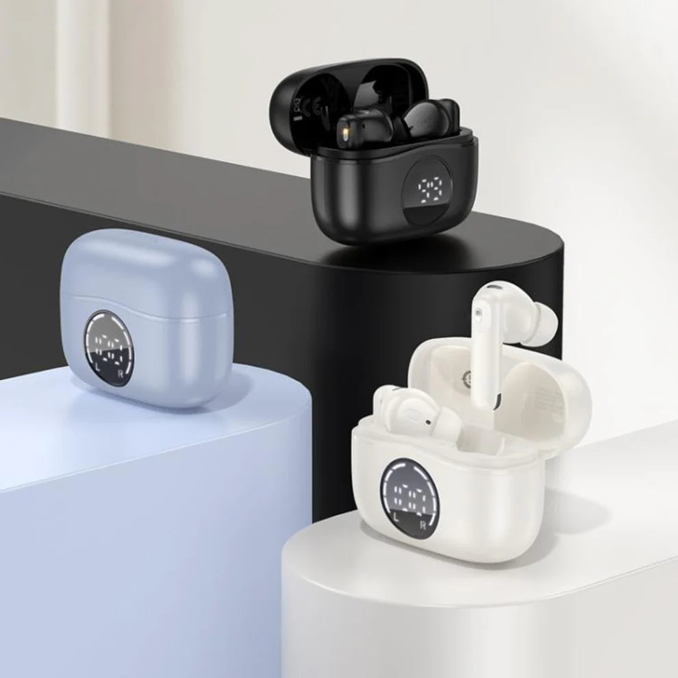 Wireless earbuds with charging cases on a modern surface